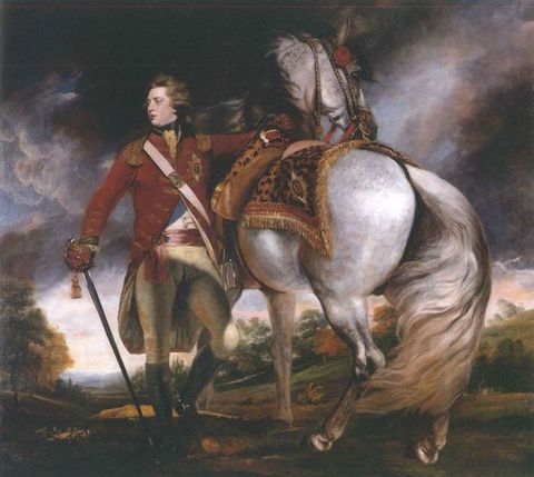 Painting. Full length portrait of a clean shaven, pale-skinned man, George the Fourth, wearing a military uniform stands next to a silvery-white horse. The man’s body faces us as he turns to look off to our left, almost in profile. He holds a sword by one side. The horse faces away from us so the tail blows across its back legs. Dark grey, blue, and purple clouds roil in the sky above.